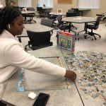 Student putting together puzzle