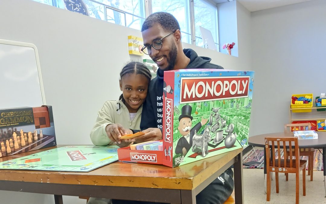 A man and a girl playing a board game
