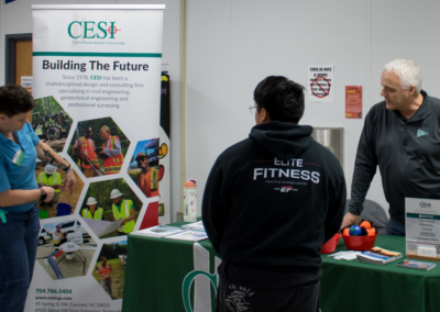 A man and woman from CESI talks with a student about the company.